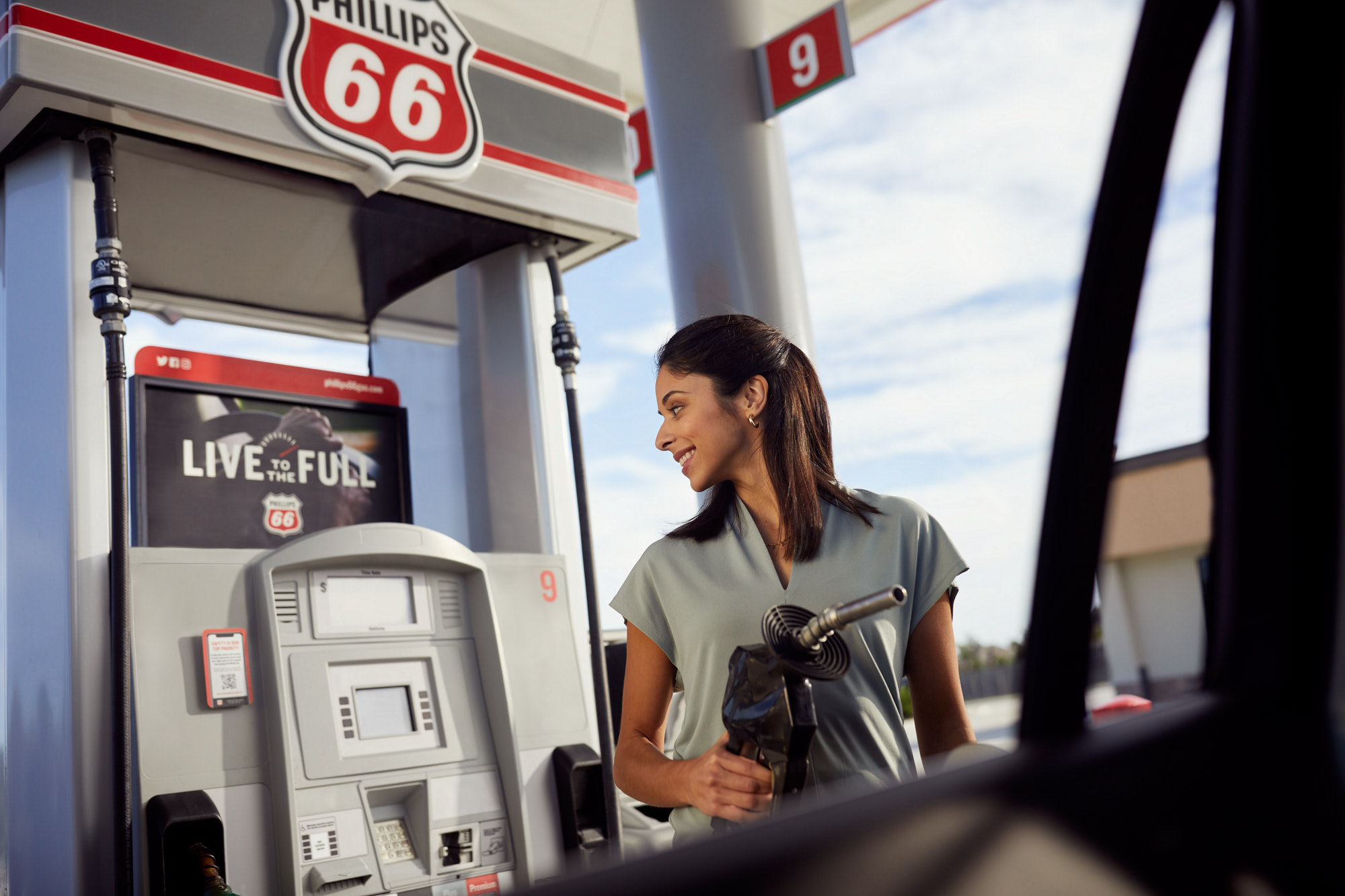 Smiling Woman Refuels | Brand Lifestyle Photography