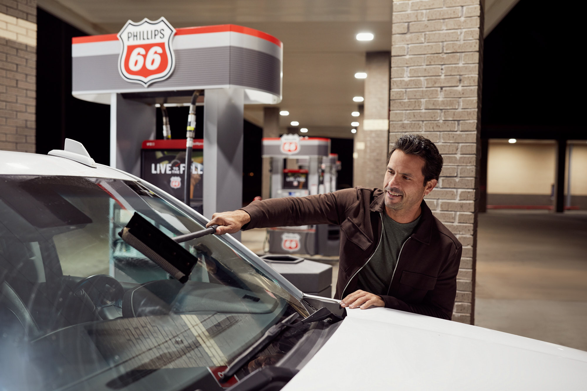 Man Cleaning Windshield at Clean Service Station | Brand Lifestyle Photography